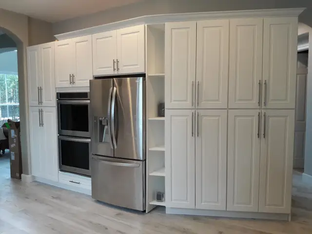 Dark wood kitchen cabinet installation in progress